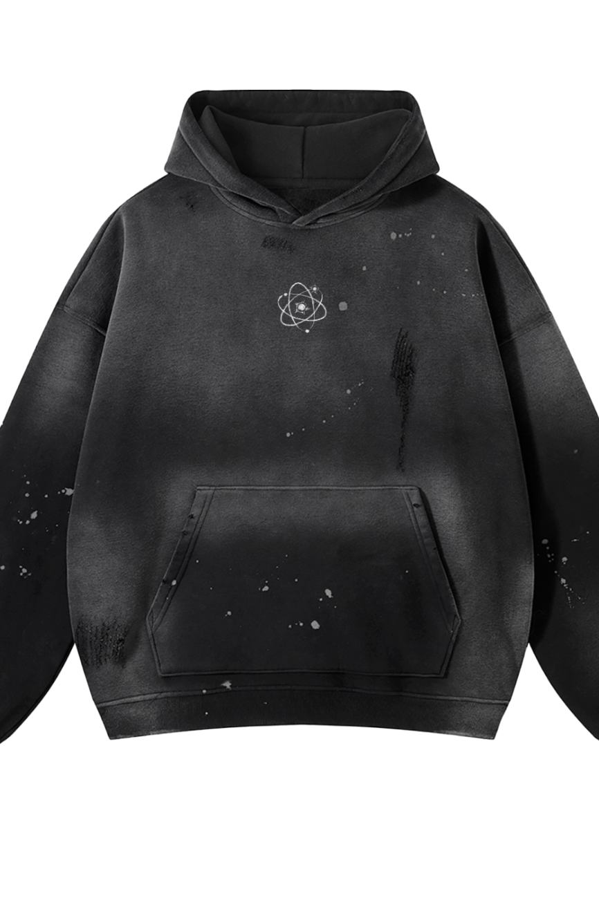 The Fusion Core - Vintage Wash Frayed Fleece Hoodie (360 GSM) features a black, bleached splatter design, a white atom symbol on the left chest, front pocket, and relaxed fit—blending affordable luxury with comfort.