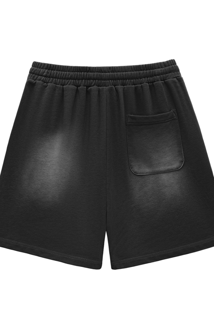 Sun Fade Raw Edge Cotton Shorts feature a soft, comfortable cotton fabric, an elastic waistband, and a single back patch pocket. Their simple black design offers affordable luxury perfect for everyday wear.