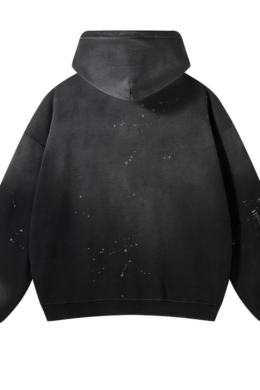 The Fusion Core - Vintage Wash Frayed Fleece Hoodie (360 GSM) is a black, loose-fit hoodie shown from the back with white paint splatters on the fabric—perfect for those seeking distinctive, affordable luxury.