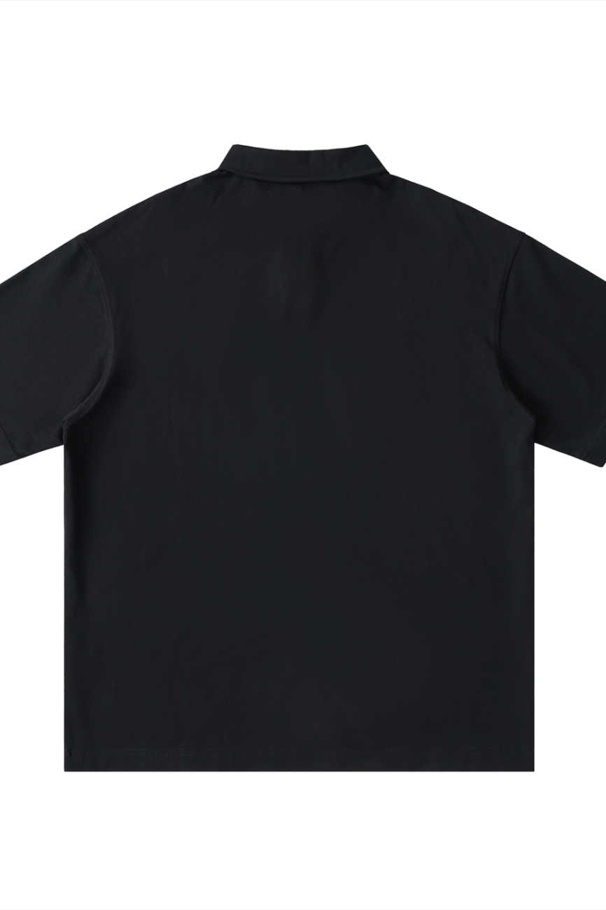 The Fusion Loose Cotton Short-Sleeve Polo Shirt, an affordable luxury piece in plain black, is shown from the back on a white background, featuring a simple collar with no visible patterns or logos.