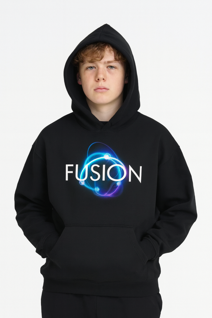 A young person with light brown hair wears the Dark Atom - Oversize Fleeced Hoodie, showcasing affordable luxury. The black hoodie features FUSION and a glowing atomic design, with the hood up, set against a plain white background.