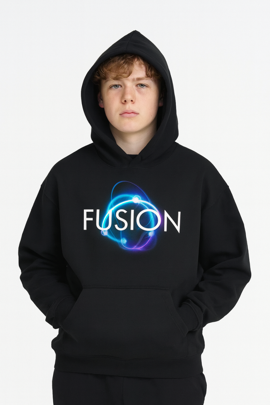 A young person with light brown hair wears the Dark Atom - Oversize Fleeced Hoodie, showcasing affordable luxury. The black hoodie features FUSION and a glowing atomic design, with the hood up, set against a plain white background.