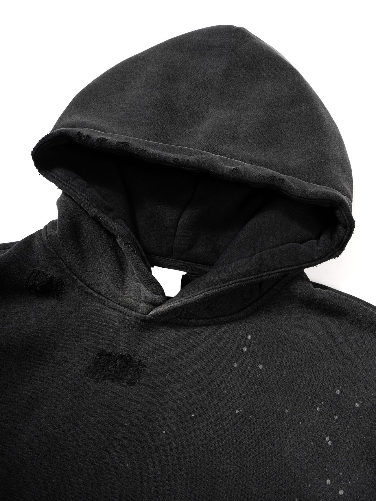 A close-up of the Fusion Core - Vintage Wash Frayed Fleece Hoodie (360 GSM) in black, featuring a hood up, distressed faded patches, and white speckles—perfect for those seeking affordable luxury. Photographed on a white background.