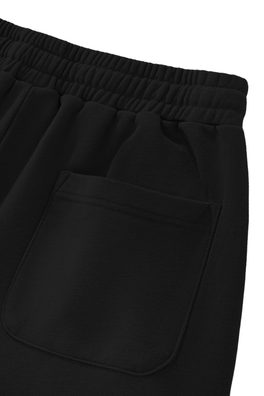 Close-up of the elastic waistband and single stitched patch pocket on Sun Fade Raw Edge Cotton Shorts, shown against a white background.