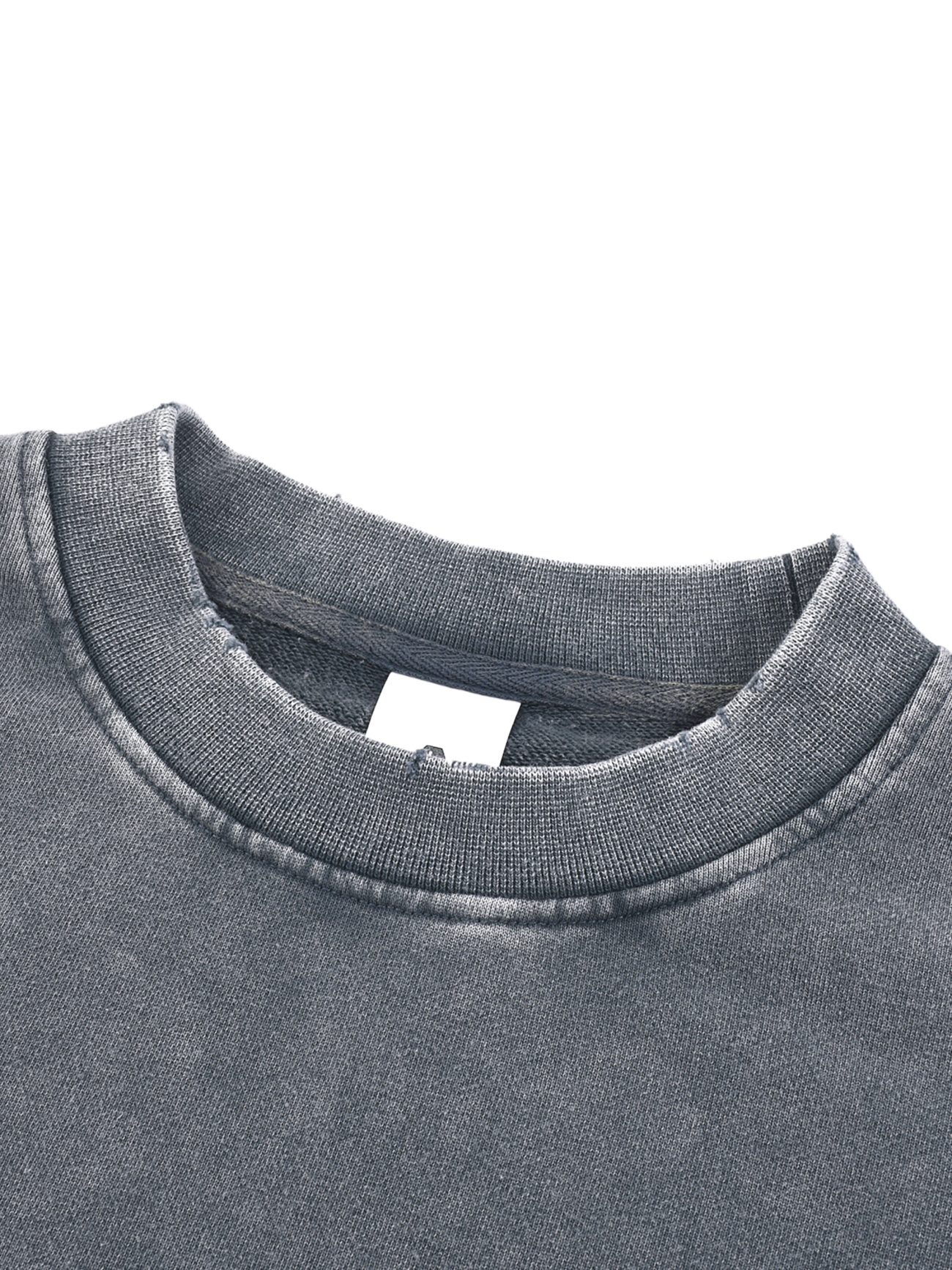 Close-up of a Womens Snow Washed Raw Edge Cropped Sweatshirt in grey, featuring a ribbed crew neckline and white blank tag inside the collar. The fabric looks soft with a slightly worn, vintage finish.