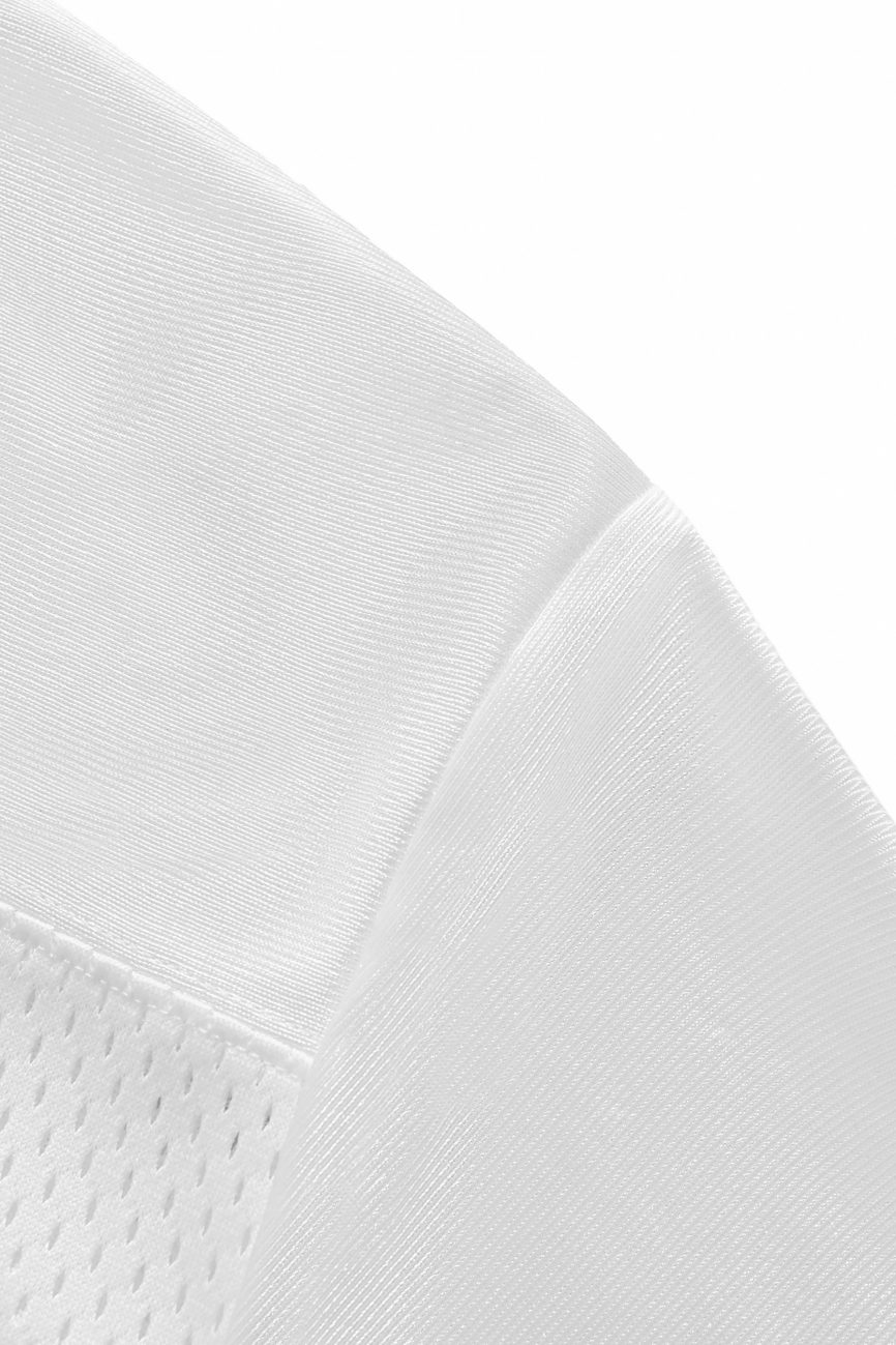 Close-up of the Fifteen - light Taped Mesh T-Shirts white fabric, featuring smooth and mesh-like textures that highlight affordable luxury details—characteristic of this stylish shirt.