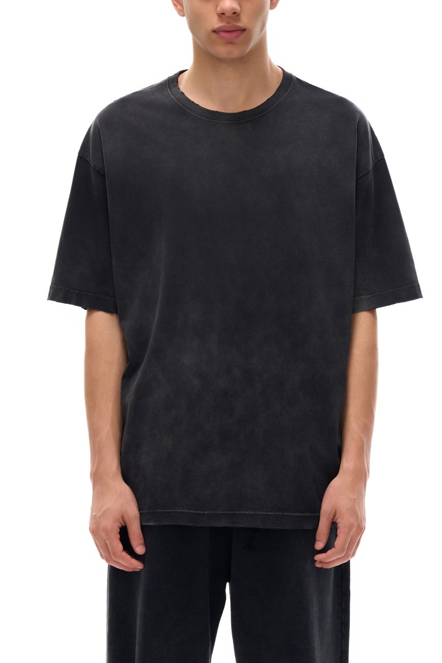 Dressed in a loose-fitting black Fusion Vintage Washed Hand-Frayed T-Shirt and matching pants, a person stands against a plain white background, with their head partially out of frame.