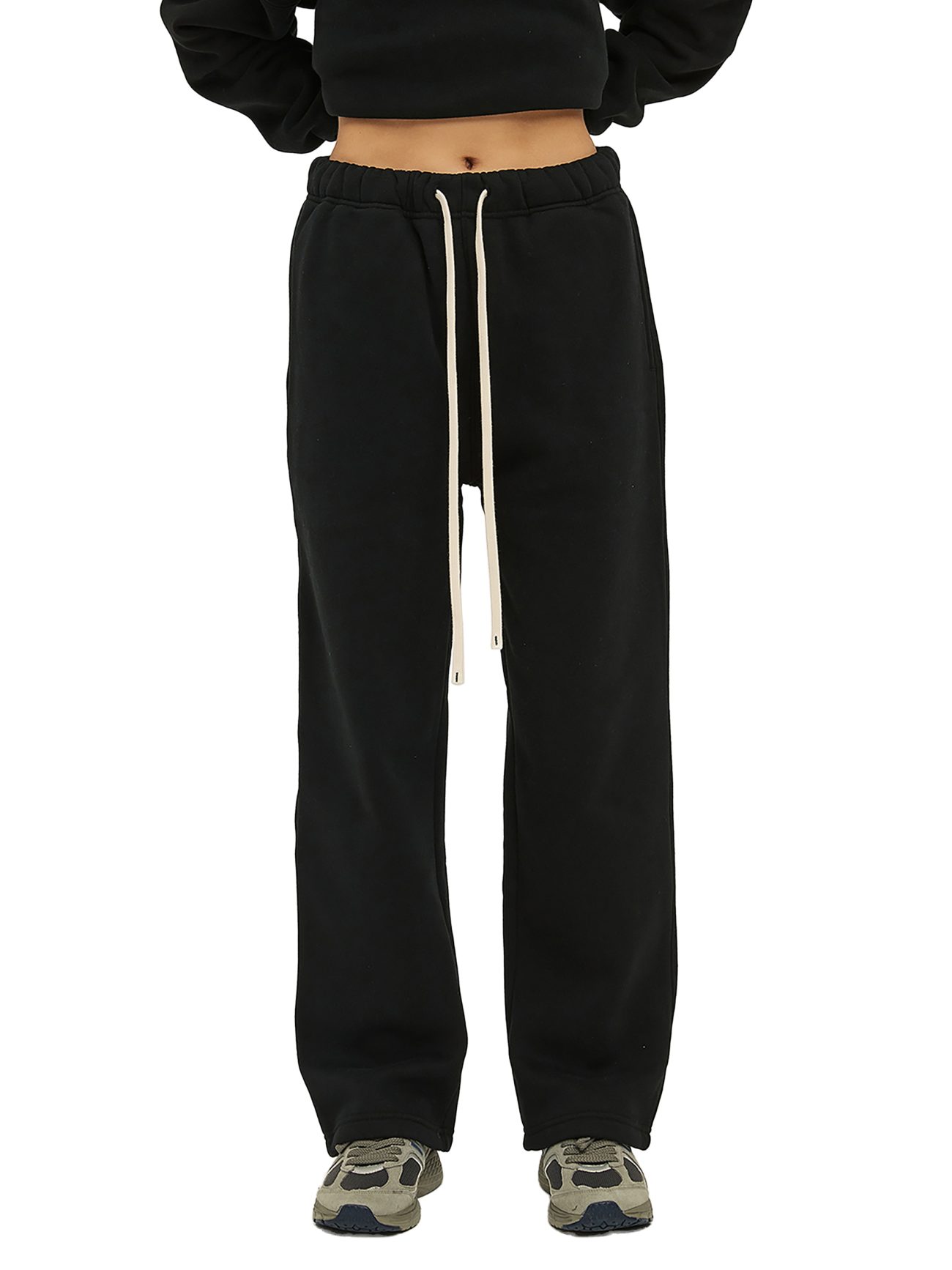 Person wearing Fusion Streetwear Unisex Solid Color Fleece Straight Leg Pants with white drawstrings, a black cropped top, and gray sneakers poses against a white background—an easy look inspired by affordable luxury.