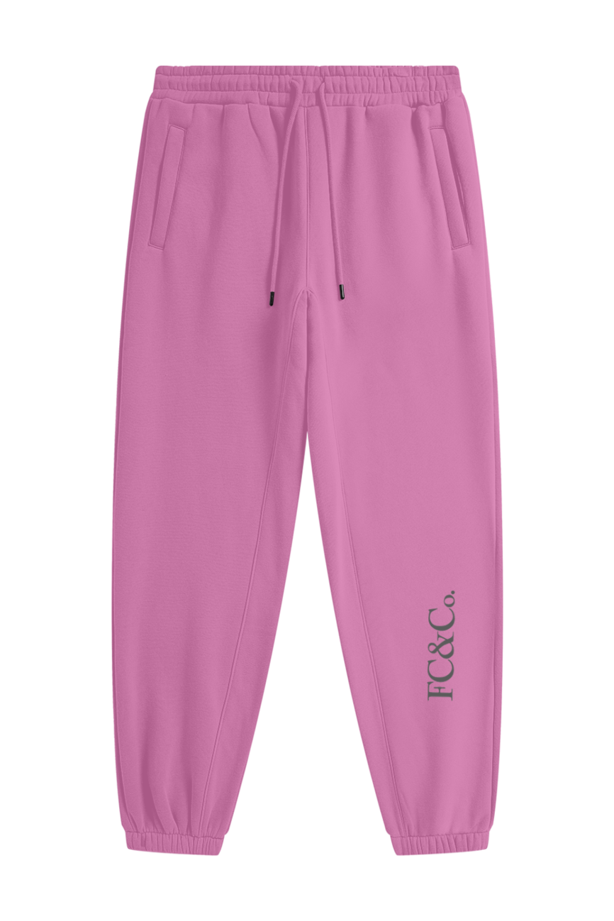 Streetwear Unisex Fleece Joggers in pink feature an elastic waistband, drawstring, and side pockets. FC&Co. in black accents the left ankle—ideal for those seeking affordable luxury and everyday comfort.