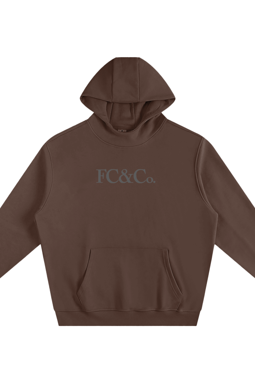 The Fleeced High Neck Hoodie is a brown hooded sweatshirt with a front kangaroo pocket and FC&Co. in gray on the chest, offering affordable luxury style. Shown against a white background.