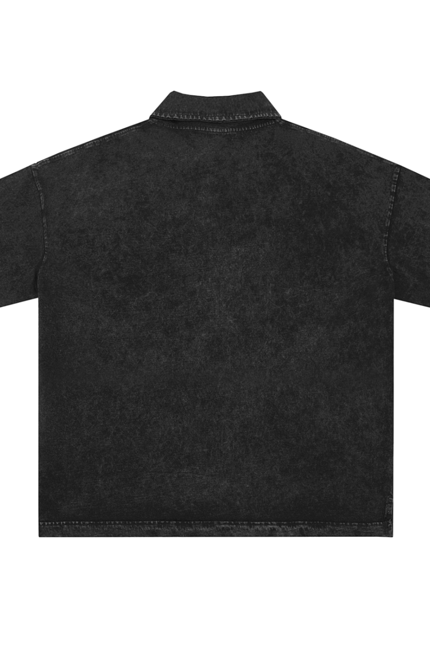 The Heavyweight Snow-Washed Polo T-Shirt from our Affordable Luxury Clothing line is shown flat, back side up on a white background, featuring a black color, short sleeves, subtle washed texture, and visible hem stitching.