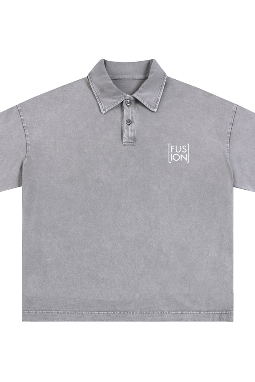 The Fusion Heavyweight Snow-Washed Polo T-Shirt is a gray, short-sleeve polo with a collar, three buttons, and a white FUSION logo on the left chest. It offers an affordable luxury look with washed fabric and visible seam stitching.