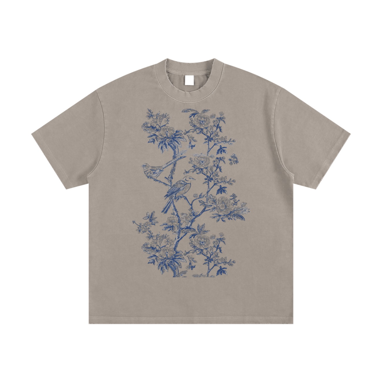 The Toile De Jouy Heavyweight Vintage Washed Frayed T-Shirt is a taupe short-sleeve tee with a detailed blue floral and bird print on the front center, offering affordable luxury for your everyday style.