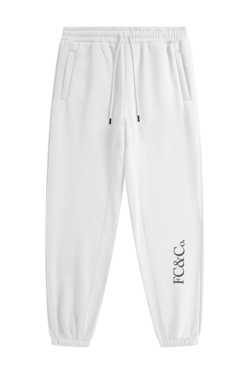 Streetwear Unisex Fleece Joggers feature an elastic waistband with drawstring, side pockets, elastic cuffs, and FC&CO. printed vertically by the left ankle—ideal for anyone seeking everyday comfort in affordable luxury style.