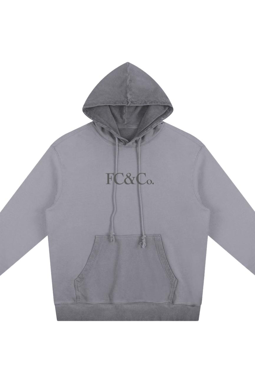 The FC&Co. - Ombre Vintage Stone Washed Colorpointed Hoodie features a gray tone, front pocket, and bold chest logo—perfect for those seeking affordable luxury. Shown laid flat on a white background.