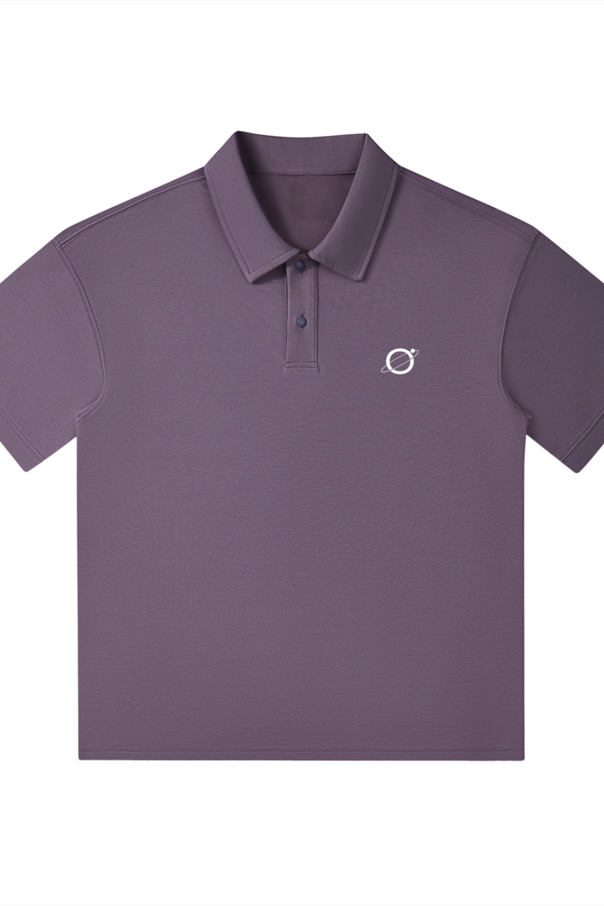 The Drop Shoulder Short-Sleeve Polo from our Affordable Luxury Clothing line is a purple, collared polo with three buttons and a small white planet and ring logo on the left chest, set against a plain white background.