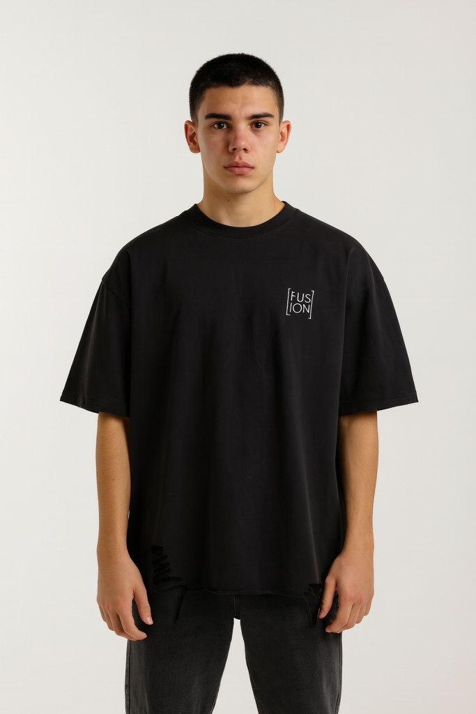 A young person with short dark hair wears the Fusion Snow Washed Raw-Hem T-Shirt, featuring a loose fit and FUSION on the chest, standing against a plain light background and looking at the camera with a neutral expression.
