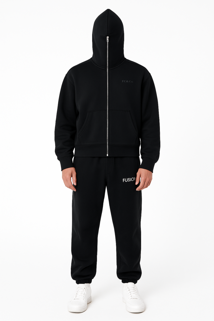 A person stands facing forward in an FC&Co. Fleeced Full-Zip Boxy Hoodie with the hood up, black FUSION sweatpants, and white sneakers—displaying affordable luxury apparel against a plain white background.