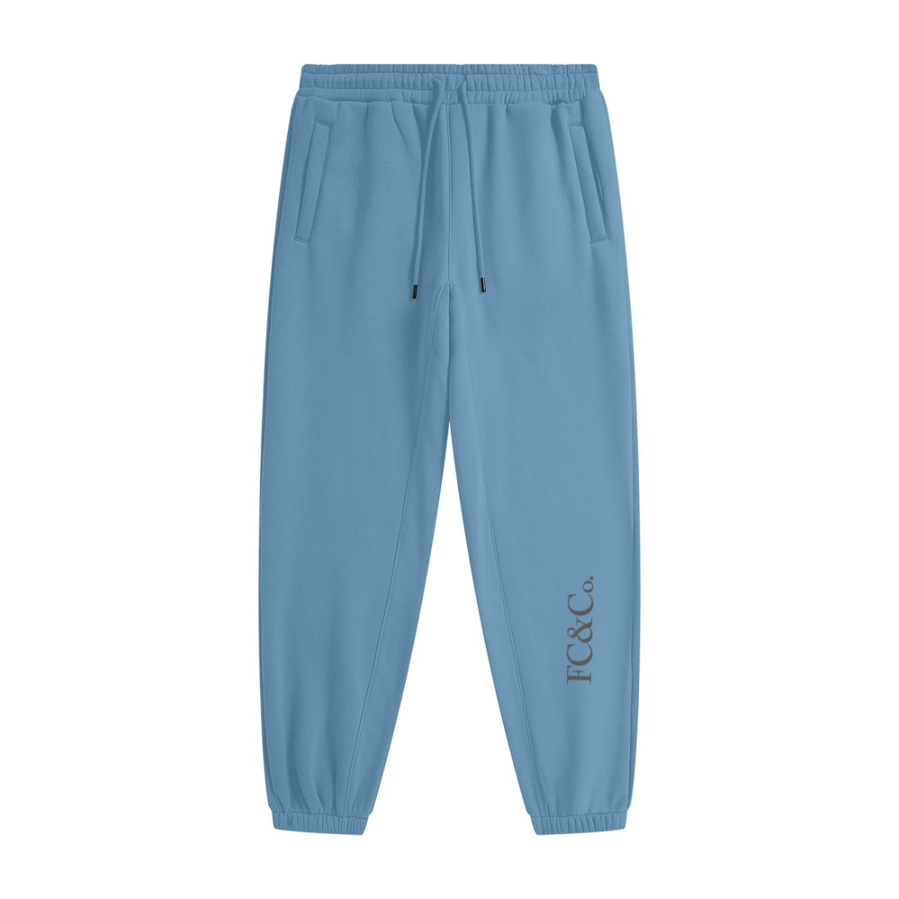 The Streetwear Unisex Fleece Joggers feature light blue fabric, an elastic waistband with drawstring, side pockets, cuffed ankles, and JTC & Co. printed vertically near the lower left leg—blending style and comfort for affordable luxury.