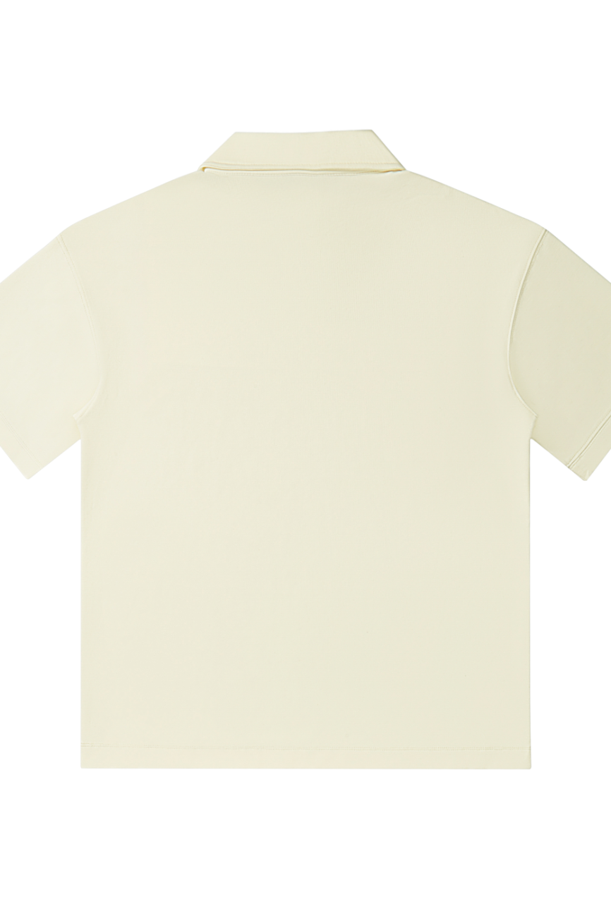 Back view of the Drop Shoulder Short-Sleeve Polo in cream, featuring a plain design and laid flat on a white background—ideal for those seeking affordable luxury with timeless appeal.