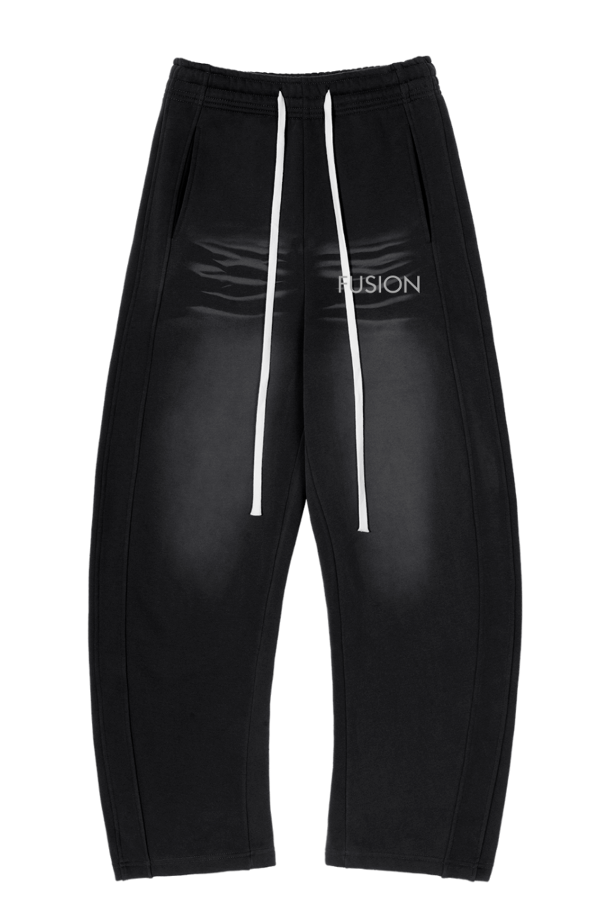 The Sunfade Curved Blade Fleece Sweatpants feature baggy black design, a shiny finish, wide legs, visible white drawstrings, and subtle FUSION print near the waistband—capturing classic affordable luxury for a standout look.