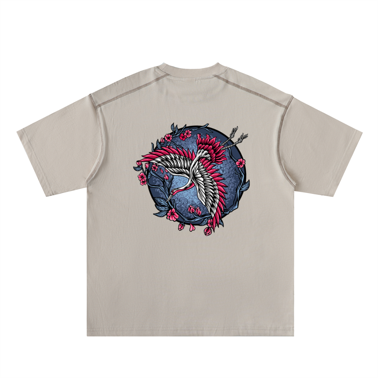 Experience affordable luxury with the Crane - Oversized Contrast-Stitched Cotton Tee, a beige shirt showcasing a white crane, red accents, pink flowers, and dark branches on a circular blue background.