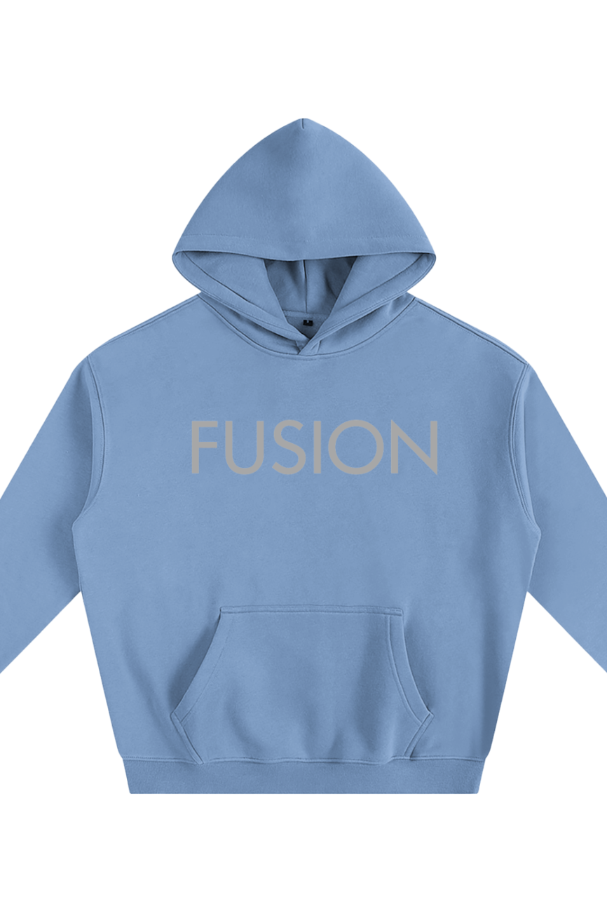 The Fusion Oversize Fleeced Hoodie is a light blue hooded sweatshirt with FUSION in large beige letters across the chest, featuring a front pocket and ribbed cuffs for comfort and style. Experience affordable luxury with this standout piece.