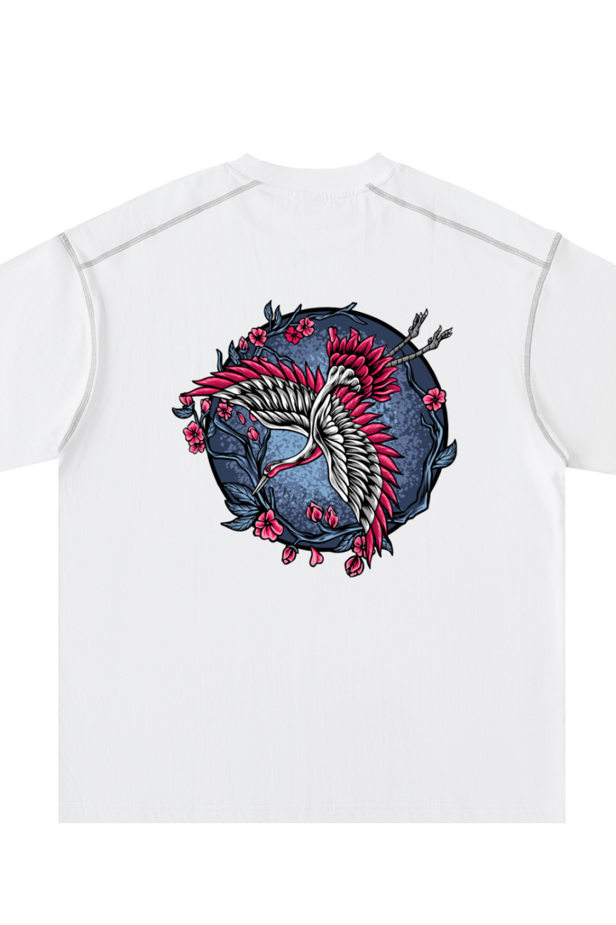 The Crane - Oversized Contrast-Stitched Cotton Tee from our Affordable Luxury Clothing line is a white T-shirt with a back graphic of two stylized cranes, pink flowers, and dark branches on a blue textured backdrop.