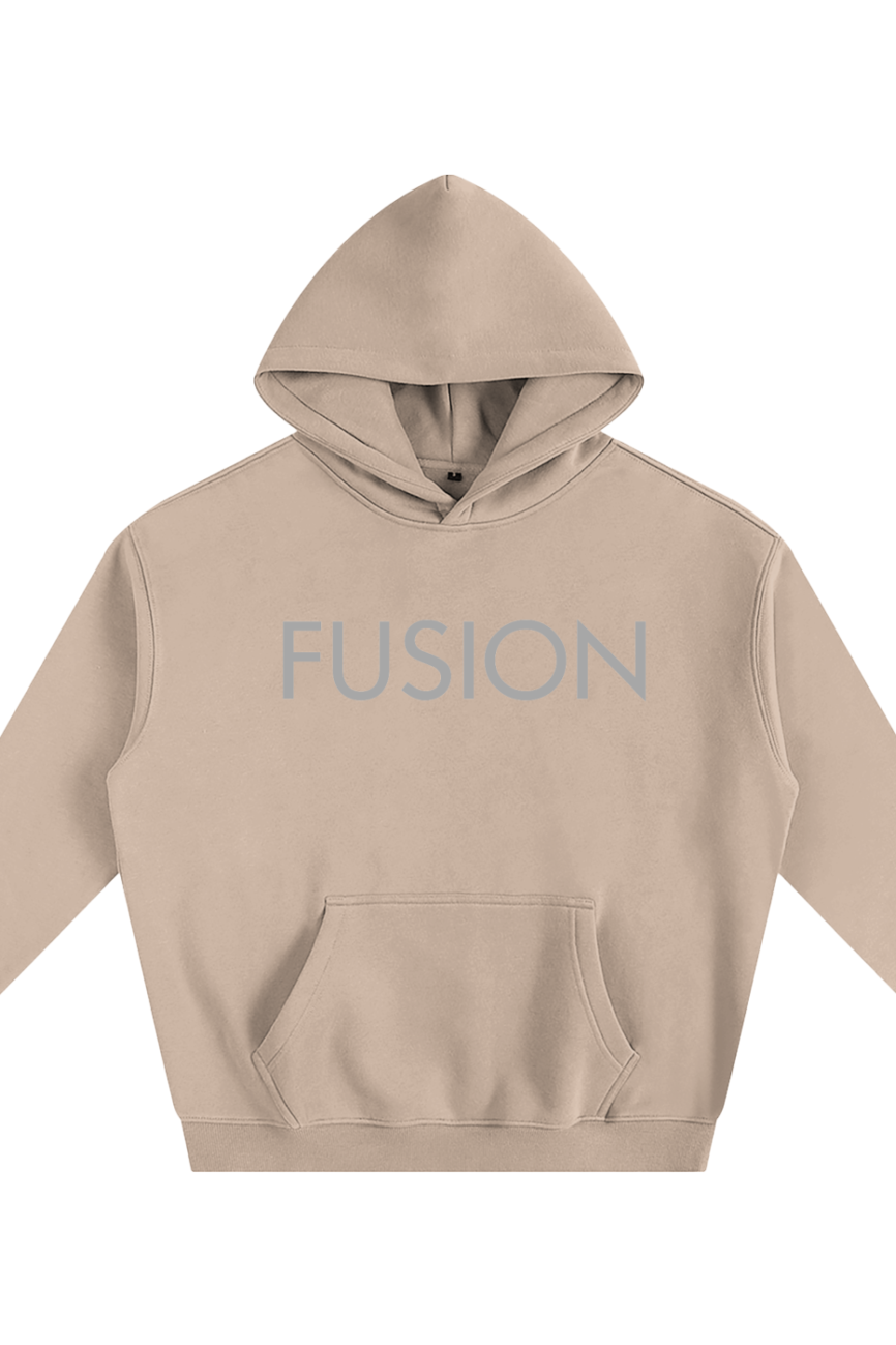 The Fusion Oversize Fleeced Hoodie is a beige, hooded sweatshirt featuring a front pouch pocket and FUSION in light gray capitals on the chest, blending affordable luxury with casual comfort. Shown laid flat on a white background.