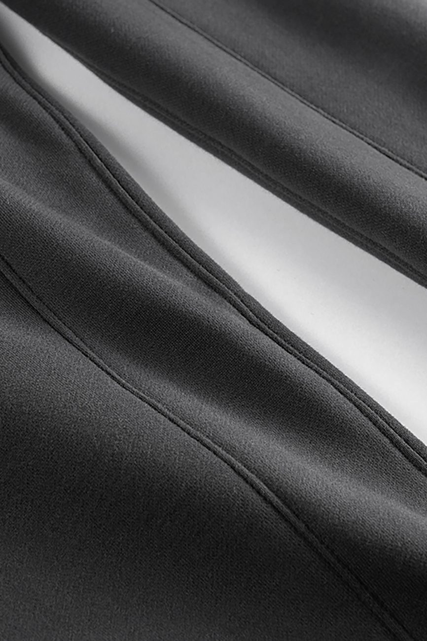 Close-up of black fabric with visible stitching and a white stripe running through the center, highlighting the sleek, modern design of Streetwear Unisex Fleece Joggers—affordable luxury with style and comfort.