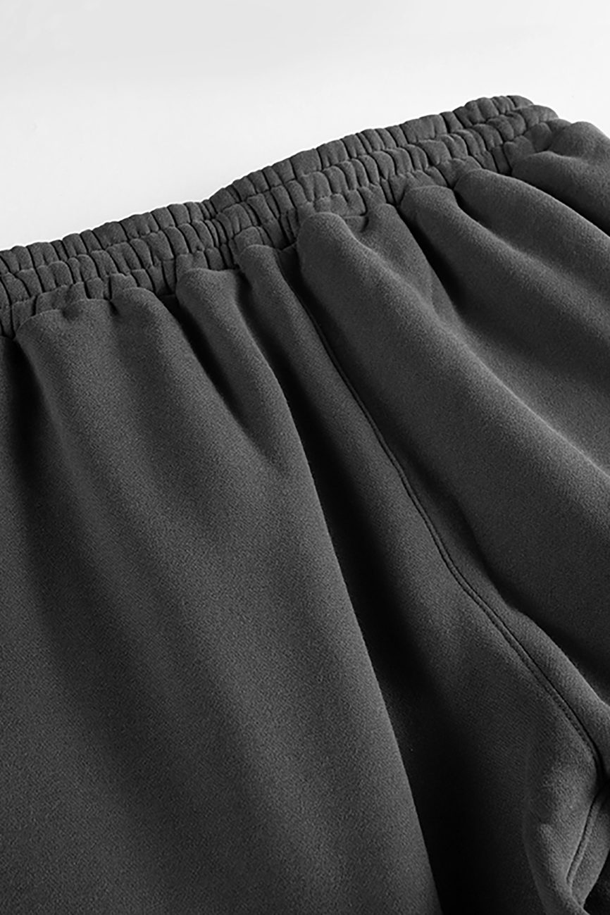 Close-up of the waistband and upper section of Streetwear Unisex Fleece Joggers, featuring an elastic waist and soft, textured black fabric—an ideal example of affordable luxury streetwear.