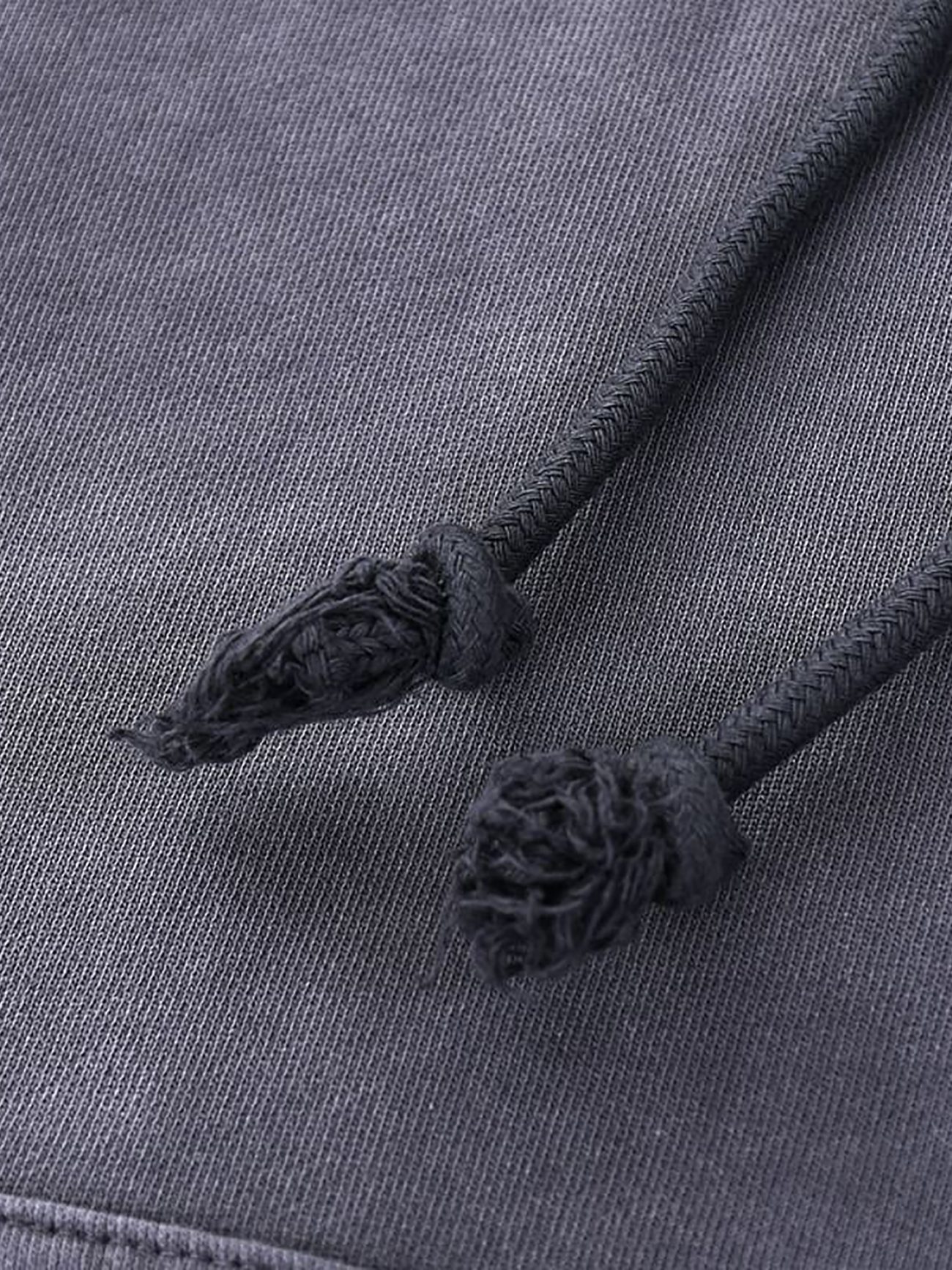 Close-up of two black hand-frayed drawstrings on dark grey fabric from the Company Heavyweight Pure Cotton Hand-Frayed Monkey Washed Hoodie, highlighting the refined details of this affordable luxury piece.
