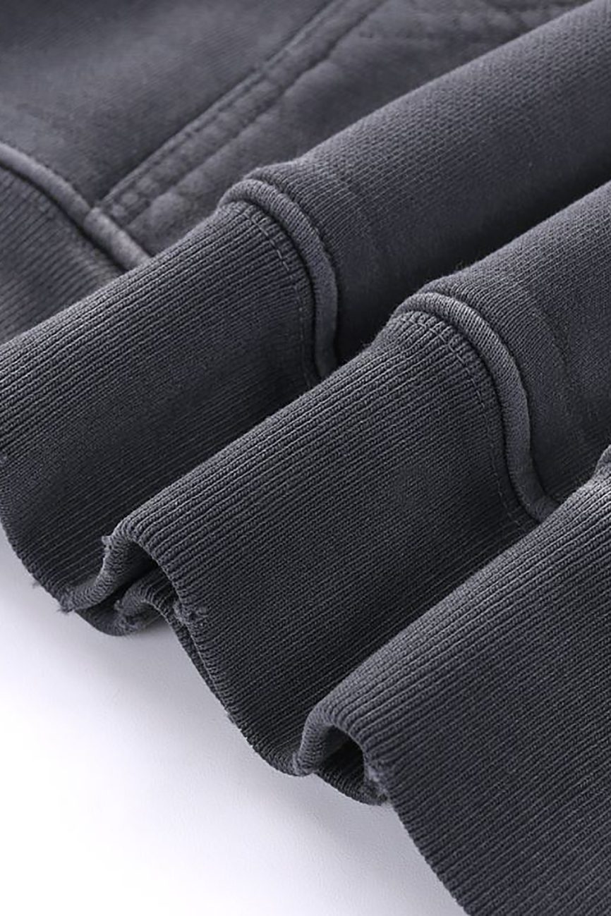 Close-up of ribbed cuffs on the Company Heavyweight Pure Cotton Hand-Frayed Monkey Washed Hoodie, showcasing fabric texture, stitching, and soft material against a white background.