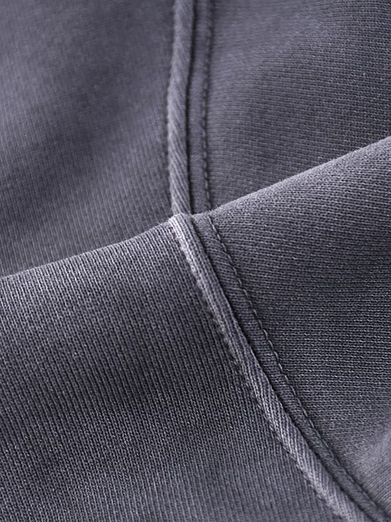 Close-up view of dark gray heavyweight pure cotton with visible stitching and seams, highlighting the texture and weave of the Company Hand-Frayed Monkey Washed Hoodie, an example of affordable luxury clothing.