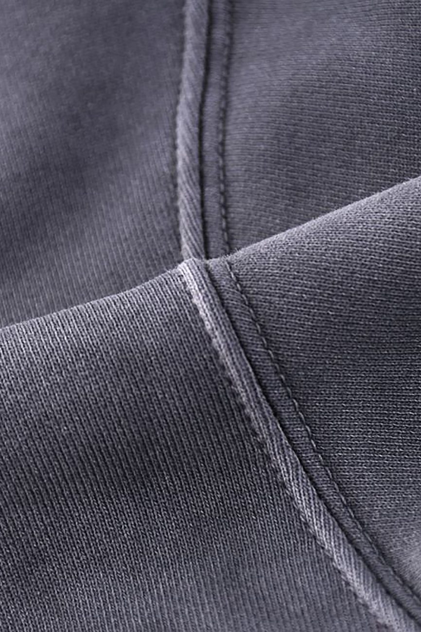Close-up view of dark gray heavyweight pure cotton with visible stitching and seams, highlighting the texture and weave of the Company Hand-Frayed Monkey Washed Hoodie, an example of affordable luxury clothing.