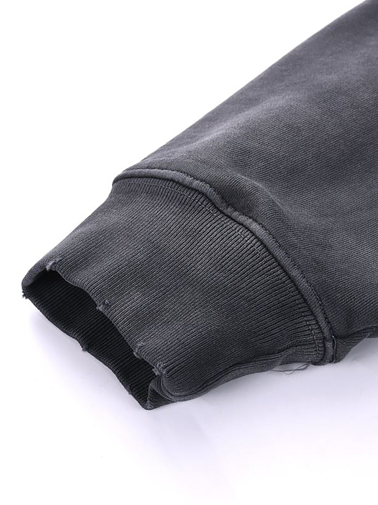 A close-up of the Company Heavyweight Pure Cotton Hand-Frayed Monkey Washed Hoodie sleeve shows ribbed cuff detailing, texture, and stitching of this affordable luxury piece against a white background.