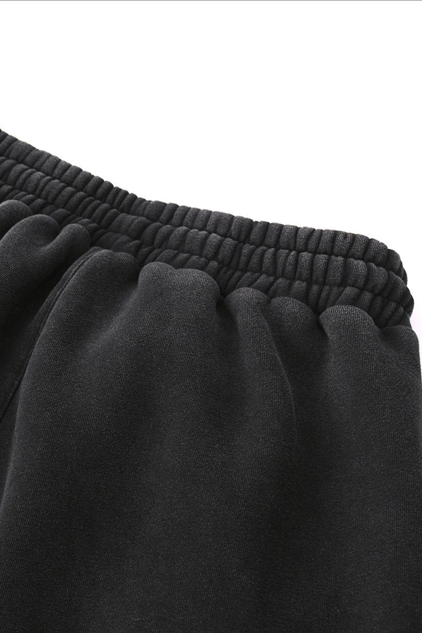 Close-up of the waistband and upper portion of the Fleeced Jogger Sweatpants, featuring a black elasticated, gathered band—perfect for those seeking affordable luxury—set against a plain white background.