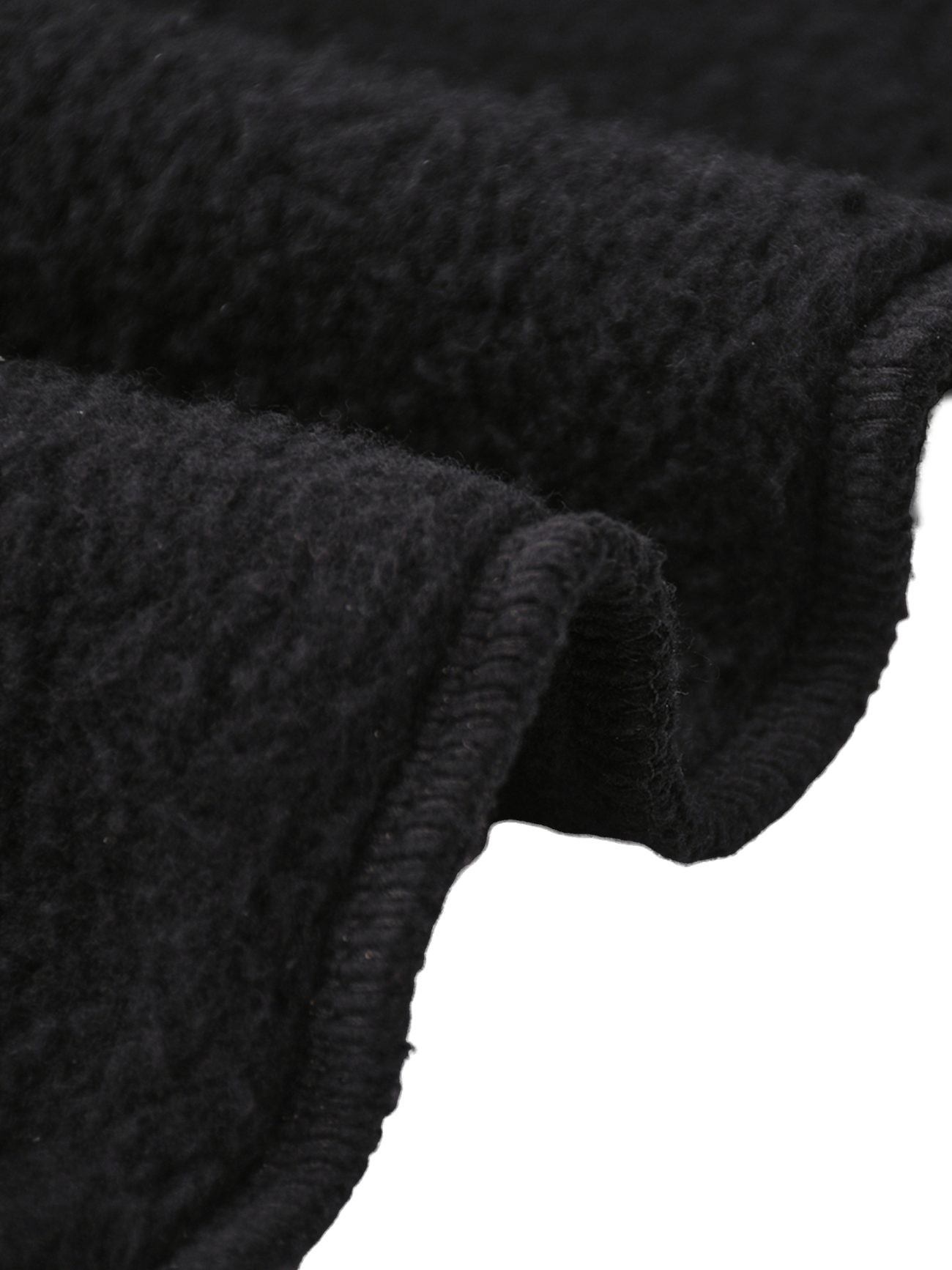 Close-up of the thick, black textured fabric used in Fleeced Jogger Sweatpants, featuring a soft, fuzzy surface and finished hem—perfect for affordable luxury clothing. Gentle, wavy folds highlight the materials comfort and quality.