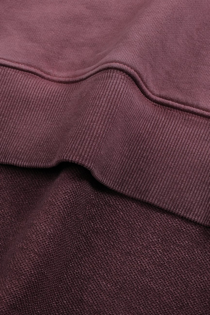 Close-up of the FC&Co. Ombre Vintage Stone Washed Colorpointed Hoodie, highlighting the textured ribbed hem and detailed stitching that define its affordable luxury appeal.