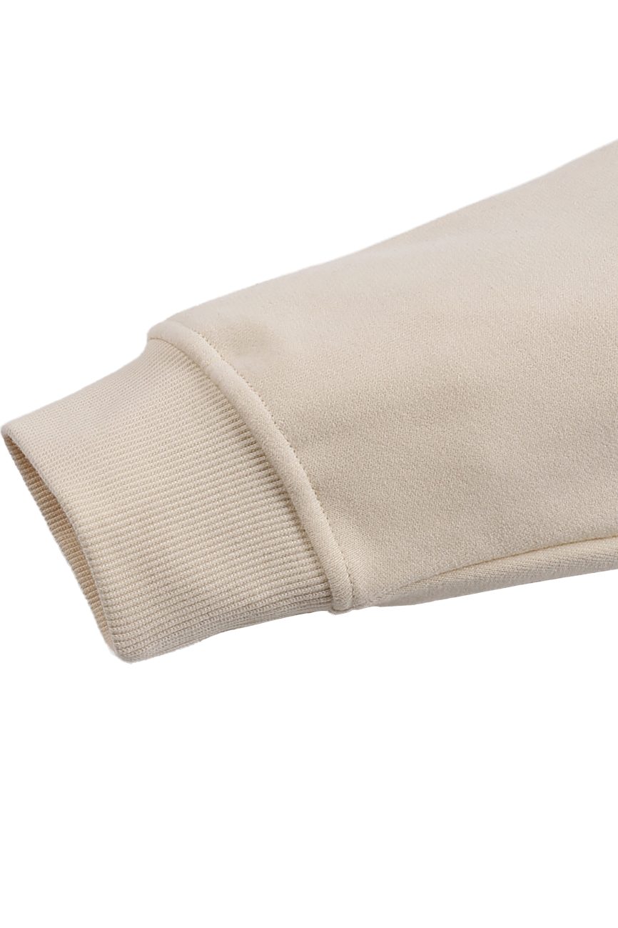 Close-up of the Fleeced High Neck Hoodie sleeve, highlighting the ribbed cuff and plush fabric—an affordable luxury piece in beige against a white background.