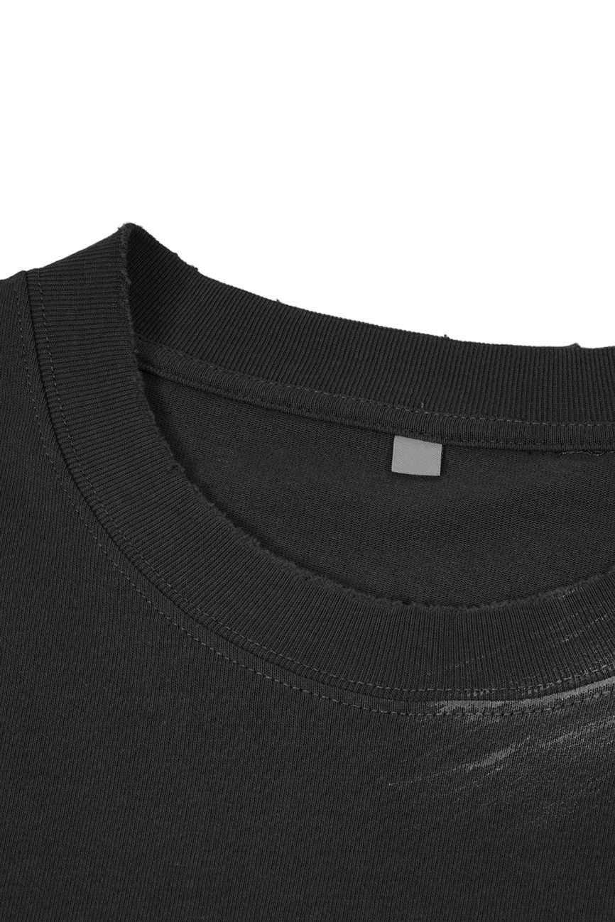 Close-up of the neckline of our Hand Brushed T-shirt, featuring a plain black crew neck, ribbed collar detail, and a small gray rectangular label inside from the Affordable Luxury Clothing line.