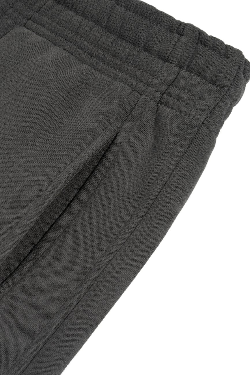 Close-up of the waistband and pocket of Sunfade Curved Blade Fleece Sweatpants, featuring an elastic waistband and side seam pocket for affordable luxury in dark gray.