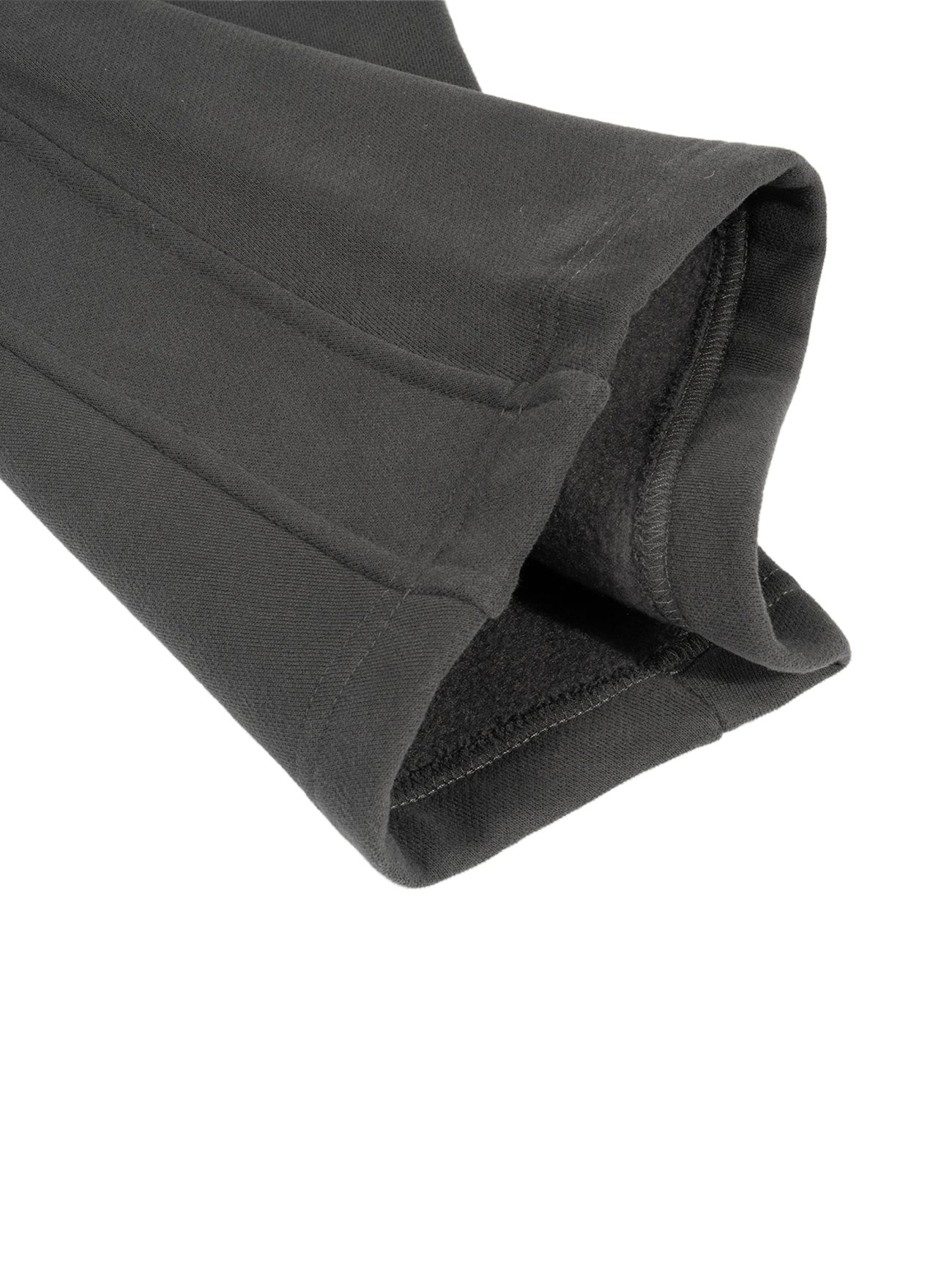 Close-up of the cuff and sleeve of our Sunfade Curved Blade Fleece Sweatpants from the Affordable Luxury Clothing collection, showing the soft fleece lining and fine stitching details.