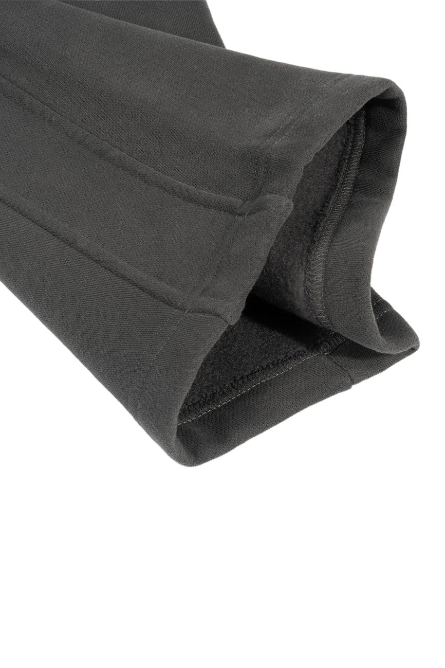 Close-up of the cuff and sleeve of our Sunfade Curved Blade Fleece Sweatpants from the Affordable Luxury Clothing collection, showing the soft fleece lining and fine stitching details.
