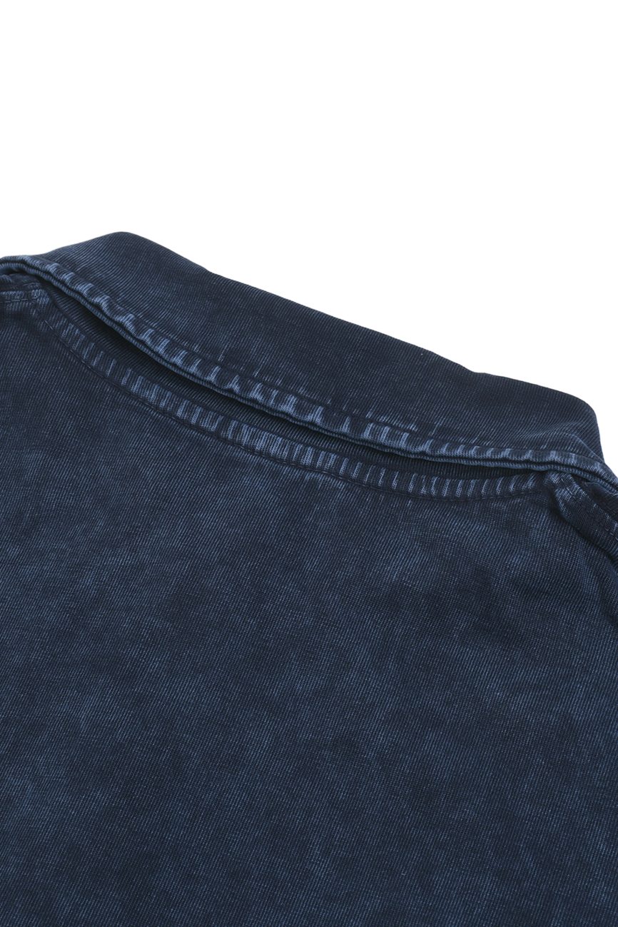 Close-up of the Fusion Heavyweight Snow-Washed Polo T-Shirt in dark blue denim, highlighting the collar and shoulder seam against a white background to showcase its fine, affordable luxury details.