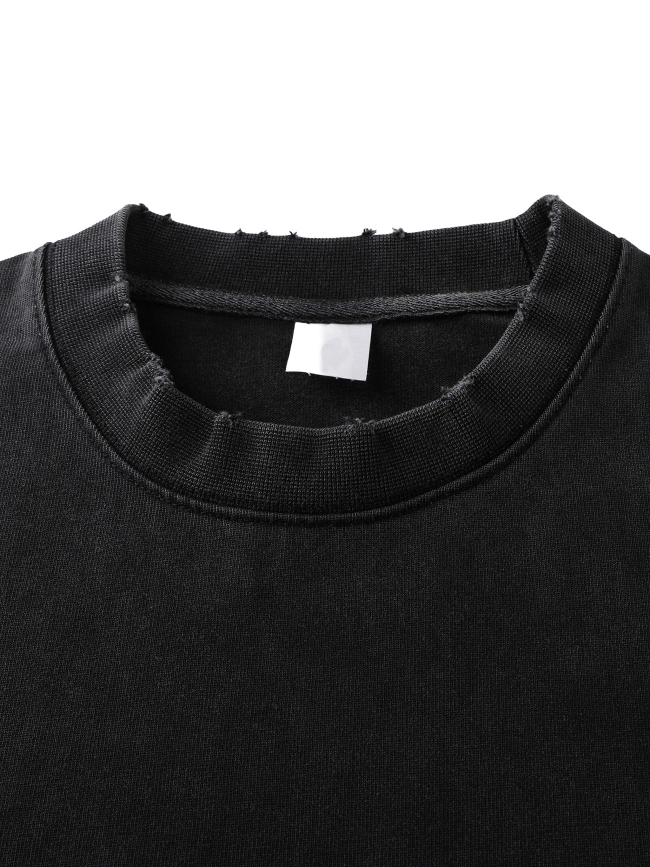 Close-up of the Toile De Jouy Heavyweight Vintage Washed Frayed T-Shirt, featuring a ribbed crewneck with a slightly distressed, frayed edge and a blank white tag inside—an embodiment of affordable luxury.