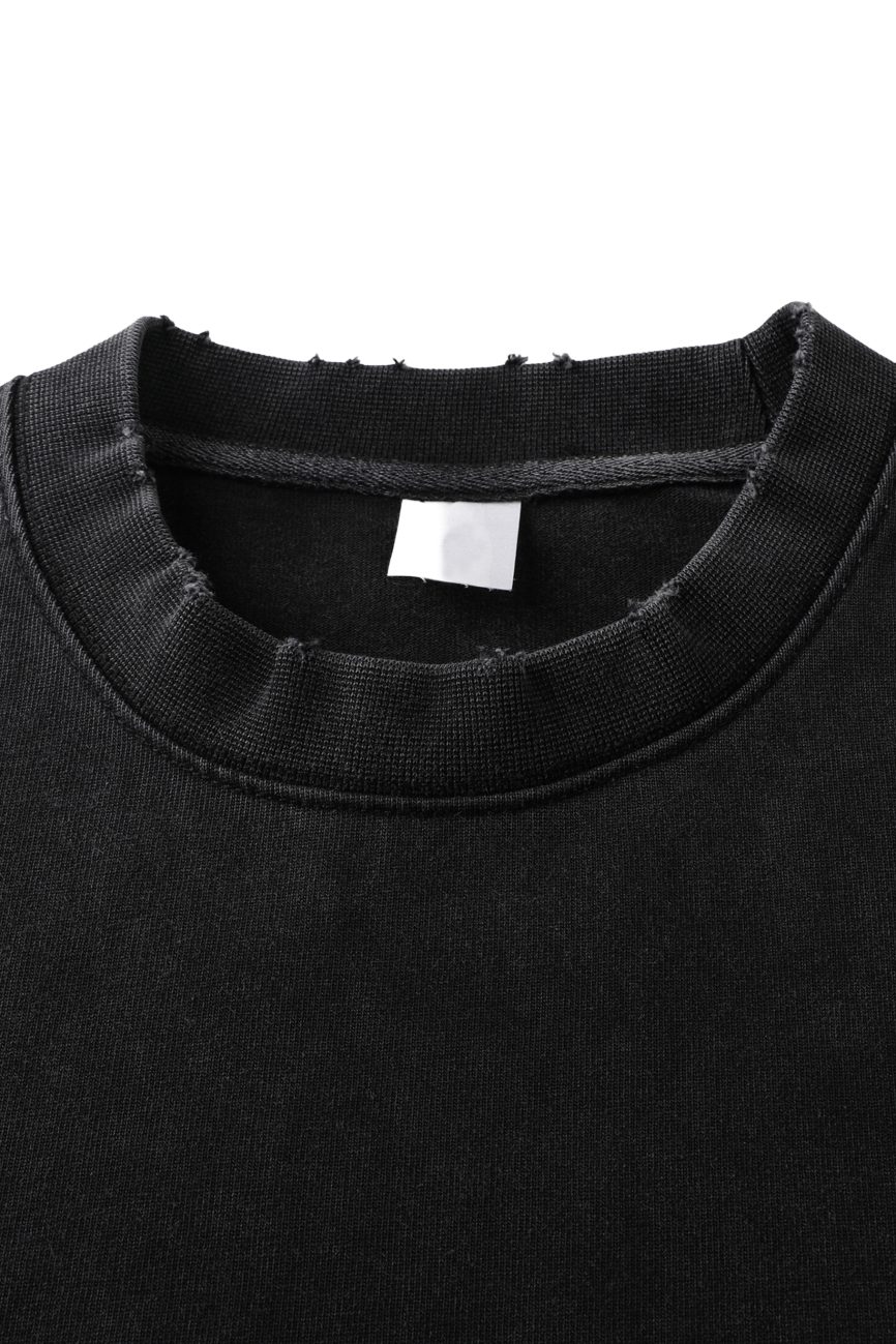 Close-up of the Toile De Jouy Heavyweight Vintage Washed Frayed T-Shirt, featuring a ribbed crewneck with a slightly distressed, frayed edge and a blank white tag inside—an embodiment of affordable luxury.