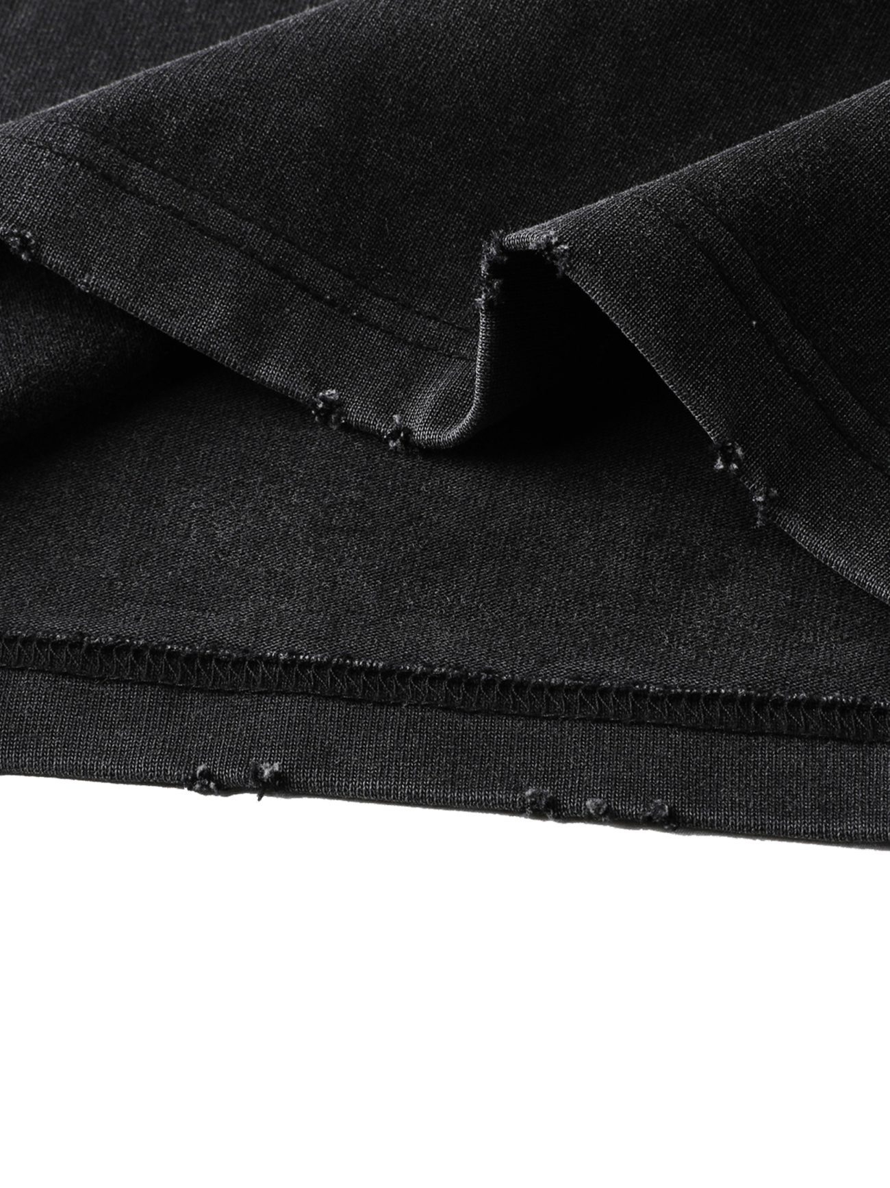 Close-up of the Toile De Jouy Heavyweight Vintage Washed Frayed T-Shirt’s black fabric, featuring raw, unfinished edges with visible stitching, slight fraying, and small holes—showcasing its artisanal affordable luxury style.