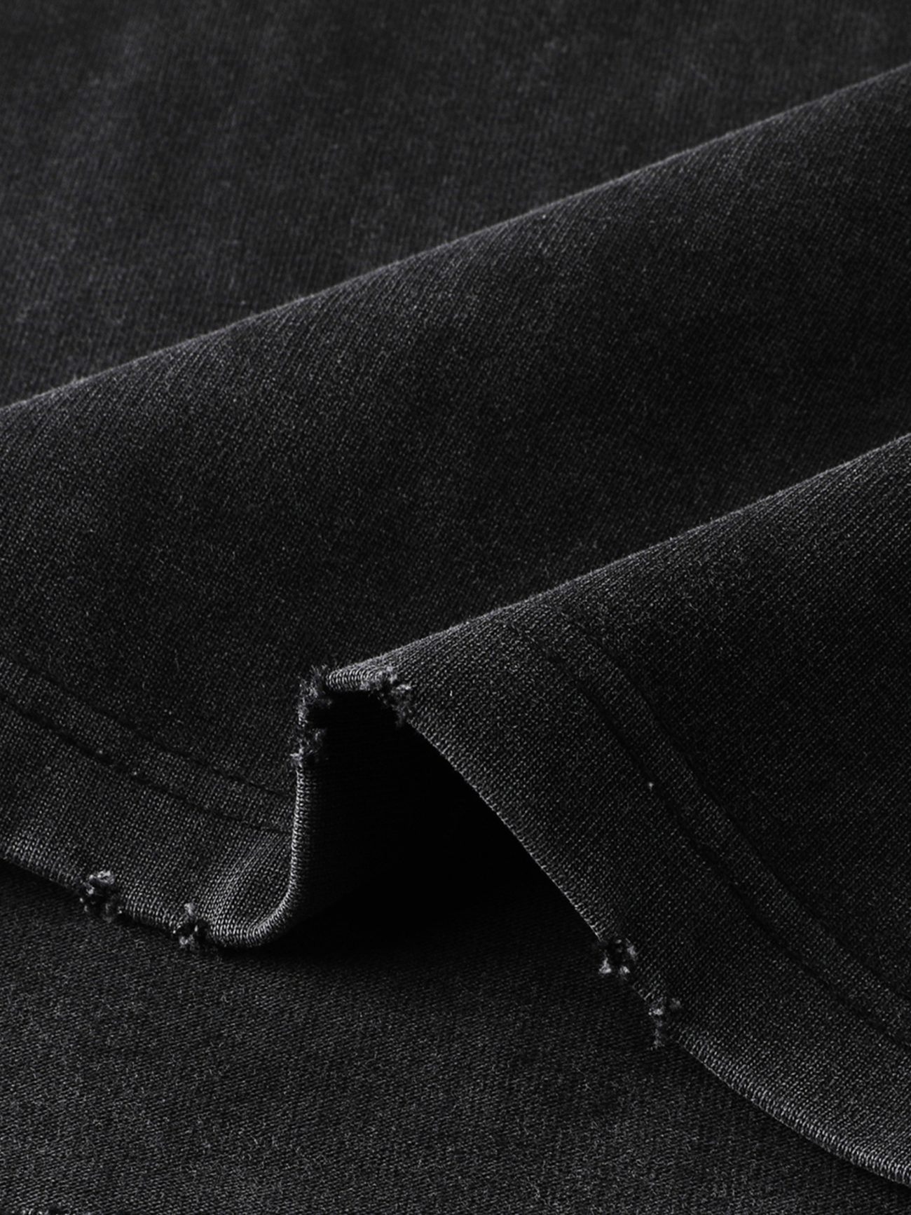 A close-up of the Toile De Jouy - Heavyweight Vintage Washed Frayed T-Shirt shows visible stitching and slightly frayed edges, highlighting the quality texture and weave typical of affordable luxury clothing.