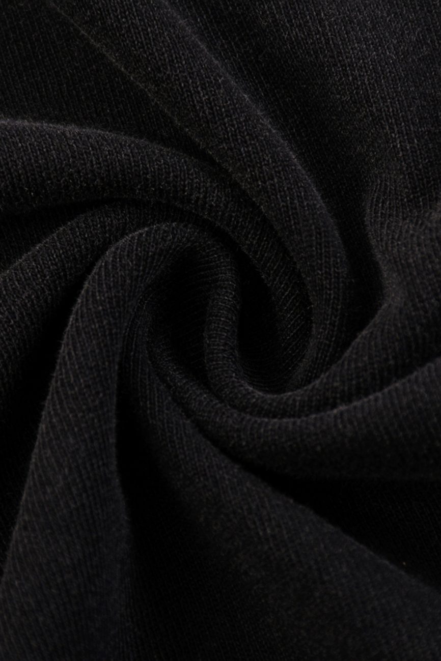 Close-up of black, soft, ribbed fabric from the Fusion Snow Washed Raw-Hem T-Shirt, arranged in a spiral to highlight its texture and gentle folds—an example of affordable luxury style.